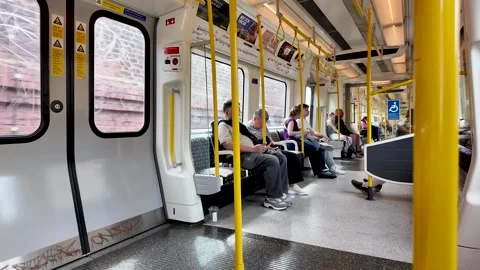 London Metropolitan Line train interior with commuters traveling, public Stock Footage 337580415
