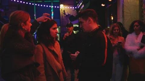 London at night -  Couple in conversation Stock Footage