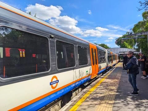 A London Overground train approaching the platform at Kew Gardens Station Stock Photos