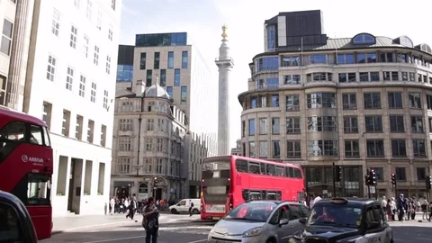 London Red Bus Passing Through City Streets in Busy Urban Traffic Stock-Footage 76763765