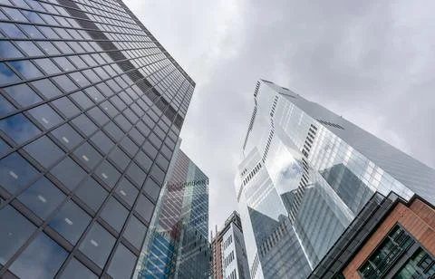 London, reflection of clouds in the windows of modern buildings Stock Photos