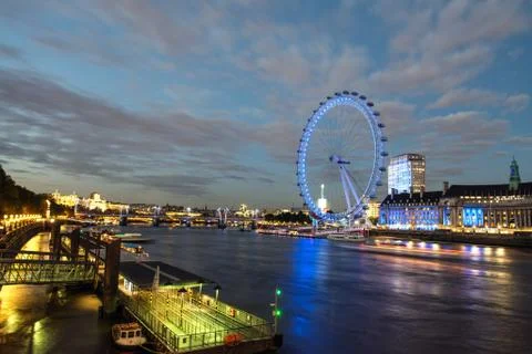London skyline at dusk from westminster bridge with illuminated london eye Stock Photos