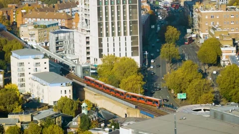 London Train Passing Over Bridge With Busy Traffic Video stock 177411075