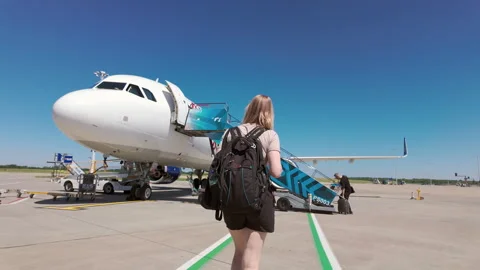London, UK - 07 26 2024: Young woman tourist with backpack goes to board plane Stock Footage 281079853
