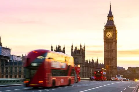 London, the UK. Red bus in motion and Big Ben, the Palace of Westminster. The Stock Photos