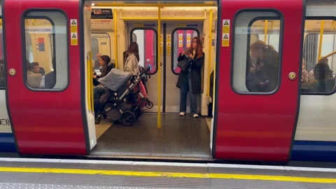 London Underground train leaves Tottenham Court Road Stock Footage 332063311