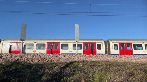 London Underground Train on a Overground Track Stock Footage 262189019