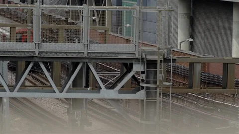 London underground train passing under metal gantry. UK. Stock Footage 93209916