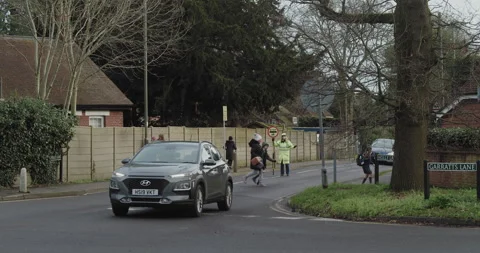 London, United Kingdom, UK - 01 18 2021:  Crossing guard outside primary school. Stock Footage