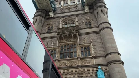 London's Iconic Double Decker Bus Driving By Revealing The Top Of Tower Bridge 動画素材 332604850