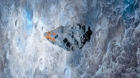 A lone asteroid rotating in outer space in front of a moon-like planet. Stock Footage 246976432