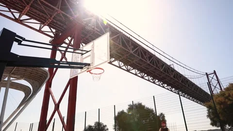 A lone basketball player throws a ball with an amazing view Stock Footage 248727982