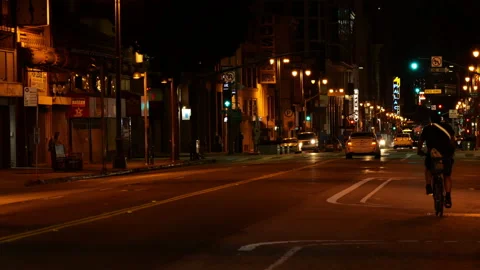 A lone bicycle riding through the Broadway Theatre District at night Stock Footage 130826258