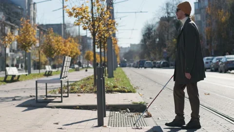 Lone blind man detecting tactile tiles, walking to pedestrian crossing safe road Stock Footage 220753168