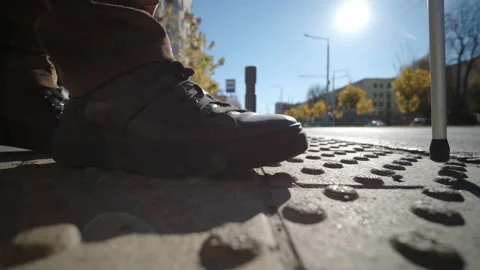Lone blind man detecting tactile tiles, walking to pedestrian crossing safe road Stock Footage 220838092