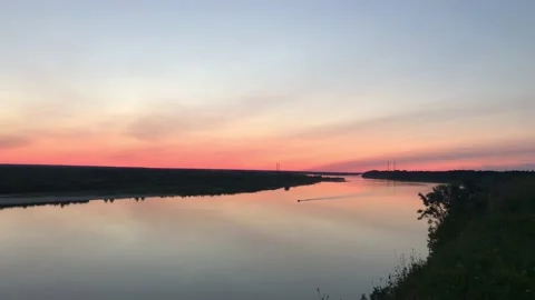 Lone boat rides along river in sunset. Arhangelsk region. Northern Dvina. Russia Stock Footage 131536732