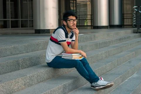 Lone brooding guy sits on the steps Stock Photos