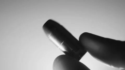 Lone Bullet Being Handled (Black and White) Stock Footage 138455079