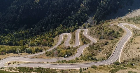 Lone car drives up empty mountain road in autumn drone aerial 4k Stock Footage 125758707