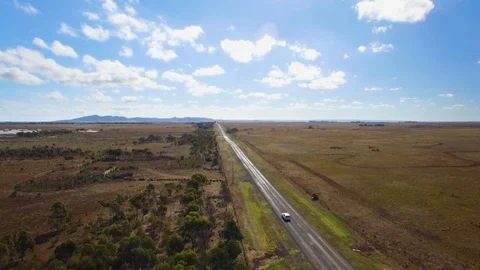 Lone car on isolated rural road in country Victoria, Australia. Stock Footage