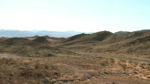 Lone car wanders through desert Stock Footage 629511