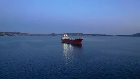 Lone cargo ship in reflective waters 4K Stock Footage 314753899