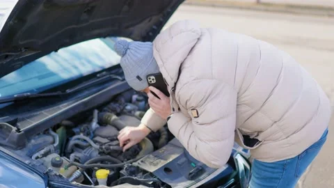 A lone driver examines the damage engine, looking Stock Footage 234690842