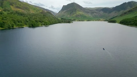 Lone figure glides across calm, deep blue waters Stock Footage 345523949