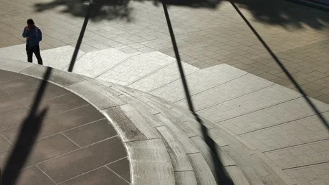 A lone figure in Silhouette checking phone 4K Stock Footage 196900092