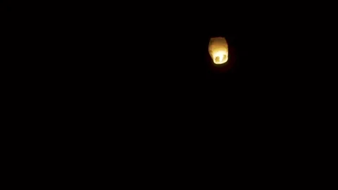 Lone glowing sky lantern in the night Video stock 336466621