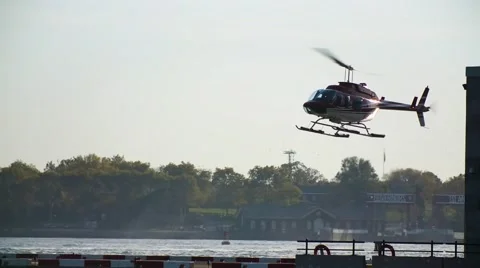 Lone Helicopter Hovers Over Dock- Slow Motion Video stock 57169400