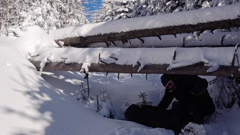 Lone Hiker Crawling Under Fallen Tree In Snowy Winter Forest Stock Footage 336503635