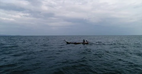 Lone longtail on gray open water under heavy cloud Stock-Footage 71300981
