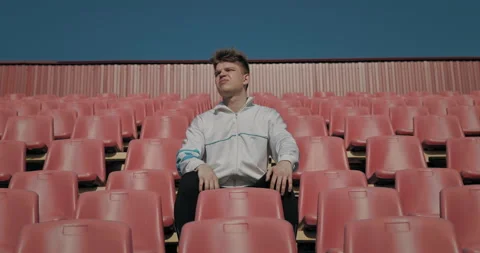 A lone man in an empty stadium is upset about the team's loss. 動画素材 152971390