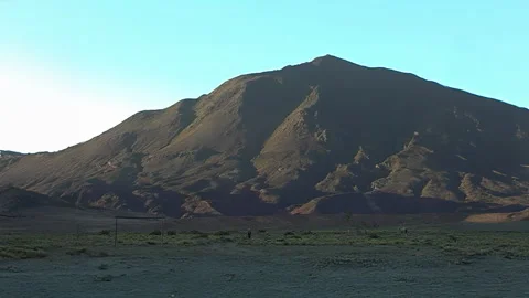 Lone Man Walking Across Vast Mountain Landscape Video stock 332246040