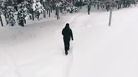 Lone Man Walking Through Snow Stock Footage