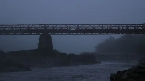 Lone man walks across bridge in the mist Video stock 11142753