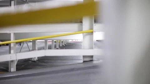 Lone man walks through deserted creepy empty car park at night Stock Footage 47486740