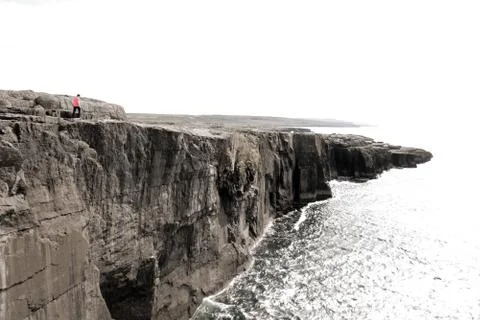 Lone person on cliffs edge Stock Photos