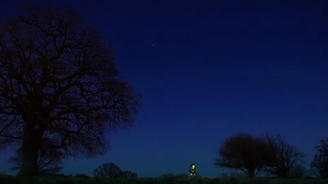 Lone person with a lantern walking at night in the countryside Stock Footage 328349853