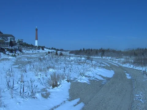 LONE PERSON WALKING IN WINTER ON BEACH TIMELAPSE Stock Footage 76584776