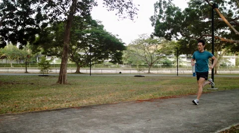 Lone runner jogging in park Stock Footage 53081252