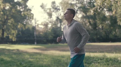 Lone runner in park, slow motion shot at 240fps Stock Footage 54056855