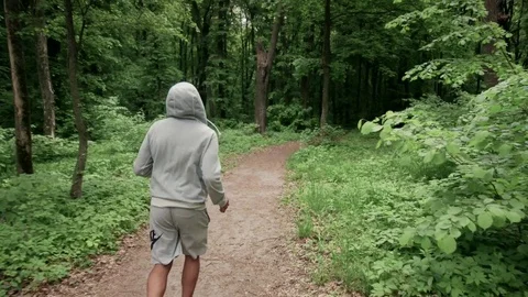 Lone runner in wintry wood, slow motion shot Video stock 75537363