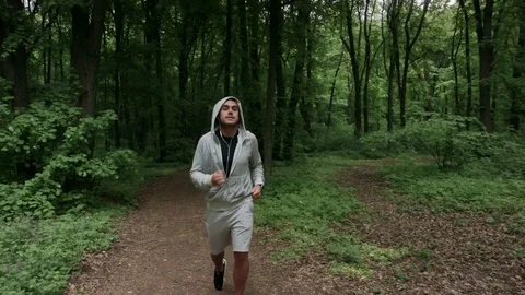 Lone runner in wintry wood, slow motion shot Stock Footage 75538479