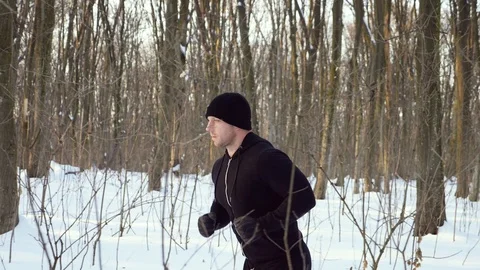 Lone runner in wintry wood, slow motion shot at 180fps Stock Footage 87920645