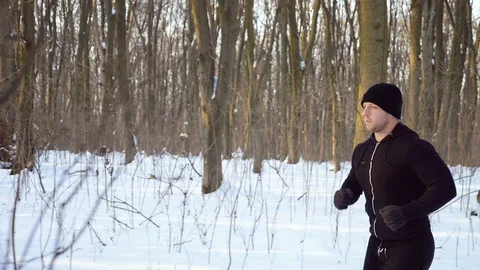 Lone runner in wintry wood, slow motion shot at 180fps Stock Footage 87920669