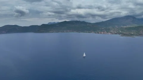 Lone Sailing Yacht Under Dramatic Storm Clouds in Greece Stock Footage 336706529