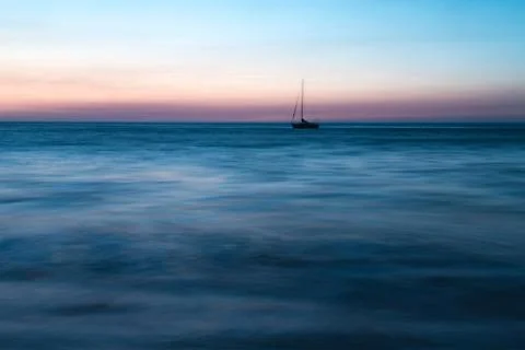 Lone ship on the ocean at sunset. Foto stock