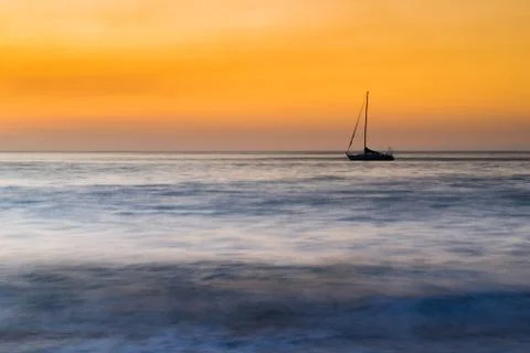 Lone ship at sunset. Stock Photos